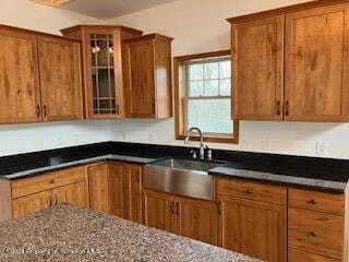 kitchen with dark stone counters and sink