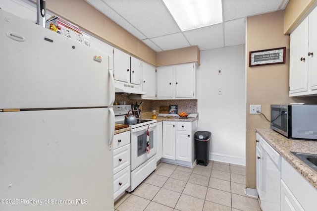 kitchen featuring light tile patterned floors, white appliances, white cabinetry, backsplash, and a drop ceiling