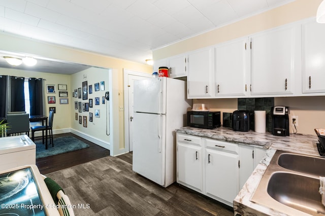 kitchen featuring white cabinetry, white fridge, dark hardwood / wood-style floors, and sink