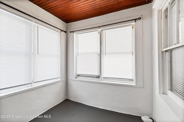 unfurnished sunroom with wooden ceiling