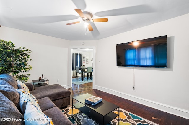 living room with wood-type flooring and ceiling fan