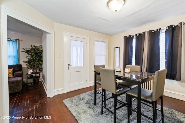 dining area featuring dark hardwood / wood-style floors