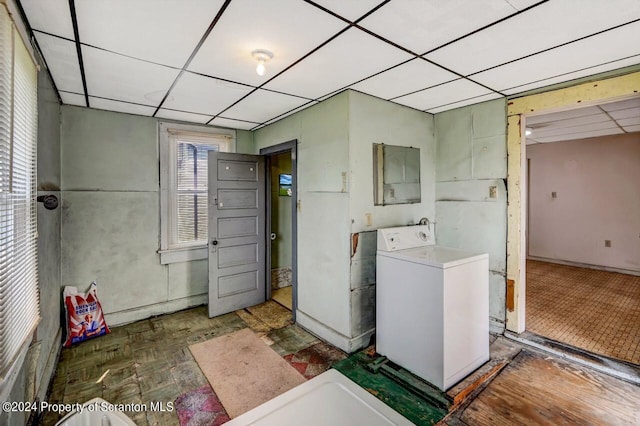 clothes washing area featuring dark parquet floors and washer / dryer