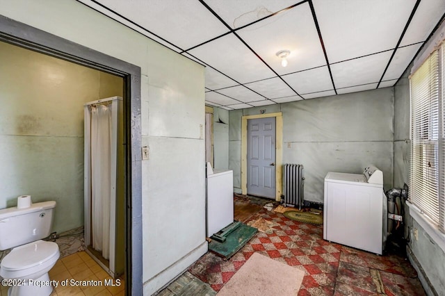 clothes washing area featuring radiator heating unit