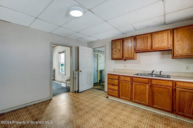 kitchen featuring a drop ceiling and sink