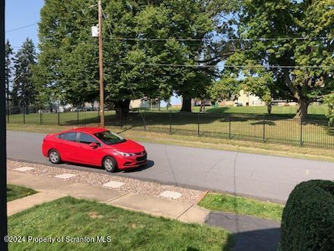 view of car parking featuring a lawn