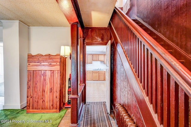 staircase featuring crown molding and sink