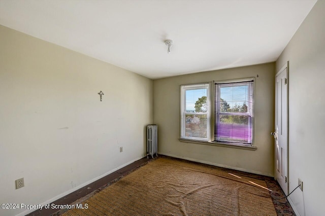 unfurnished room with radiator