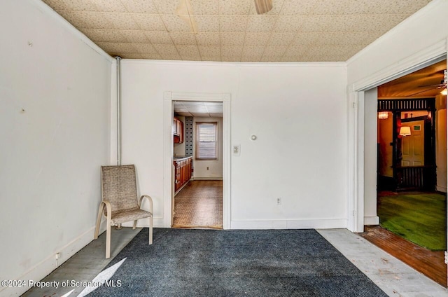 interior space with crown molding and ceiling fan