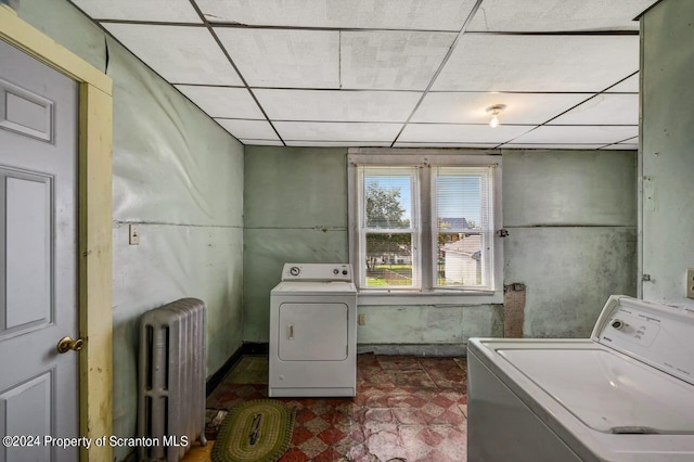 laundry room with radiator heating unit and washing machine and clothes dryer