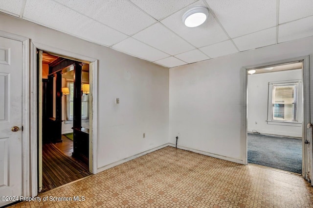 empty room featuring a paneled ceiling