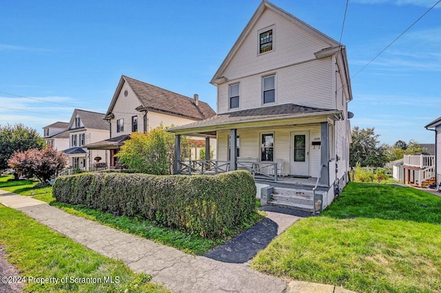 view of front of property featuring a front lawn and covered porch