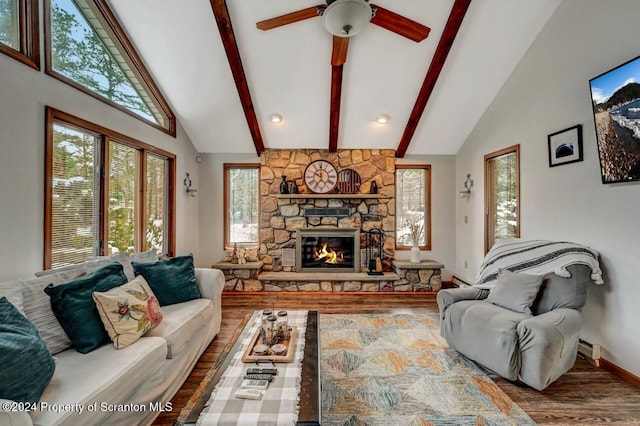 living room featuring high vaulted ceiling, a stone fireplace, ceiling fan, beamed ceiling, and wood-type flooring