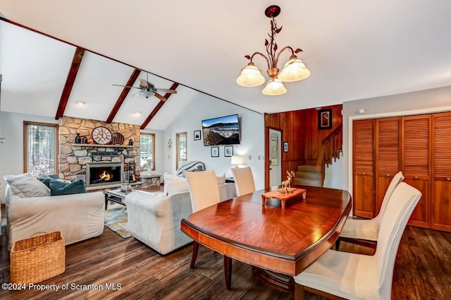 dining space featuring a fireplace, ceiling fan with notable chandelier, plenty of natural light, and dark wood-type flooring