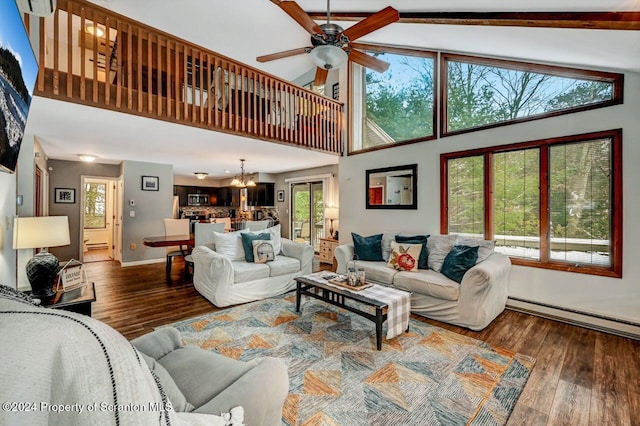 living room with high vaulted ceiling, dark wood-type flooring, and a wealth of natural light