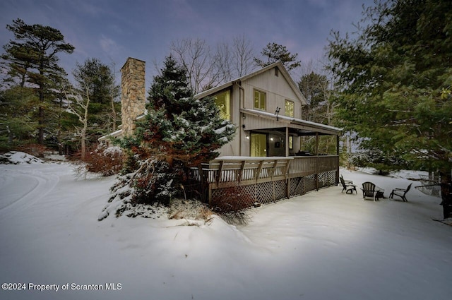 view of snow covered exterior featuring a wooden deck