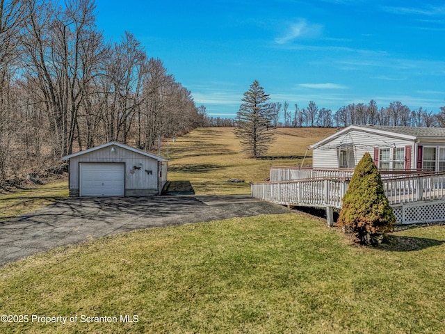815 Svecz Rd, Union Dale, PA 18470 - view of yard featuring a detached garage, an outdoor structure, a wooden deck, and aphalt driveway