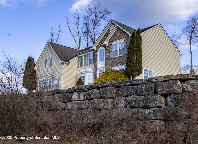 view of side of property with a lawn