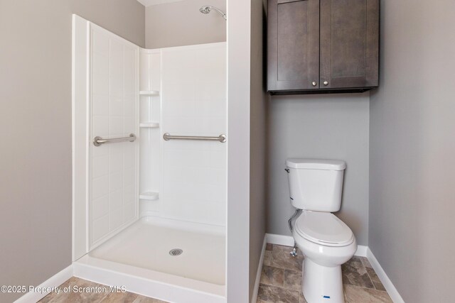 bathroom featuring toilet and a shower