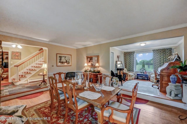 7 Lakeside Dr, Clarks Summit, PA 18411 - dining area featuring stairs, wood finished floors, a baseboard radiator, and ornamental molding