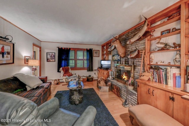 7 Lakeside Dr, Clarks Summit, PA 18411 - living room with wood finished floors, a stone fireplace, and ornamental molding