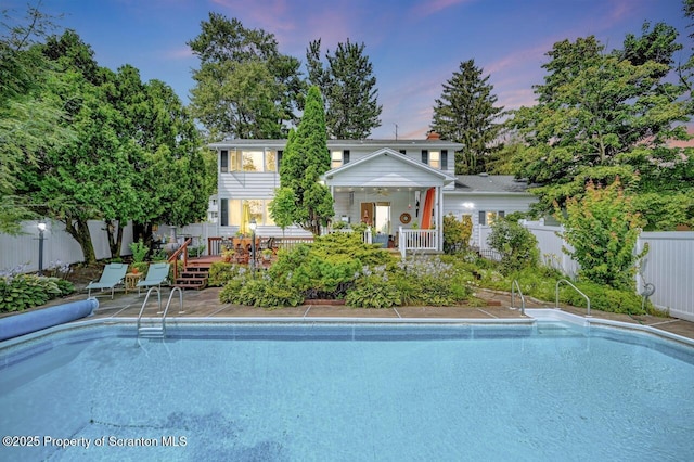 7 Lakeside Dr, Clarks Summit, PA 18411 - pool at dusk with a fenced backyard and a deck