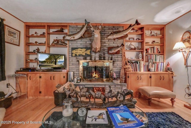 7 Lakeside Dr, Clarks Summit, PA 18411 - living area with wood finished floors, a fireplace, and built in shelves