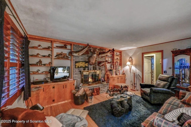 7 Lakeside Dr, Clarks Summit, PA 18411 - living room featuring wood finished floors, a brick fireplace, and built in shelves