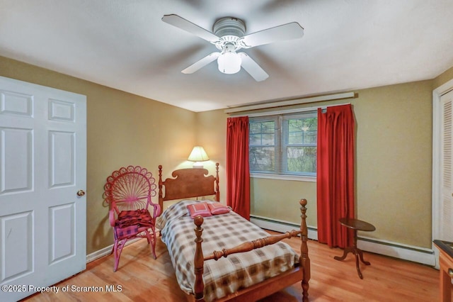 7 Lakeside Dr, Clarks Summit, PA 18411 - bedroom featuring baseboard heating, light wood finished floors, and baseboards