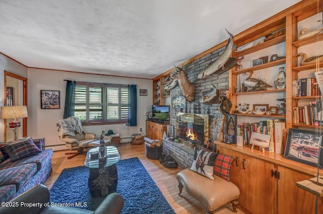 7 Lakeside Dr, Clarks Summit, PA 18411 - living area with a baseboard radiator, wood finished floors, crown molding, and a fireplace