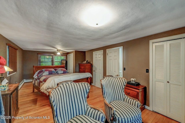 7 Lakeside Dr, Clarks Summit, PA 18411 - bedroom with light wood-style flooring, a textured ceiling, multiple closets, and baseboards