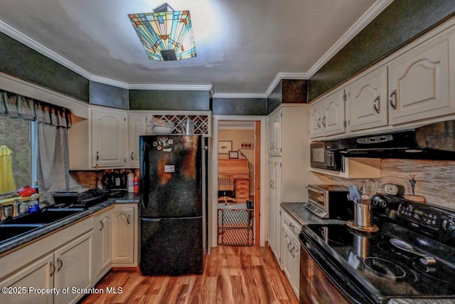 7 Lakeside Dr, Clarks Summit, PA 18411 - kitchen with black appliances, light wood-type flooring, dark countertops, decorative backsplash, and ornamental molding
