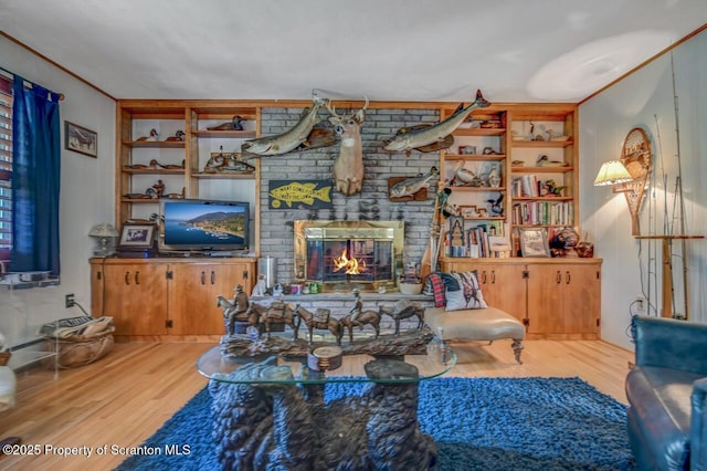 7 Lakeside Dr, Clarks Summit, PA 18411 - living room featuring wood finished floors, built in shelves, and a fireplace