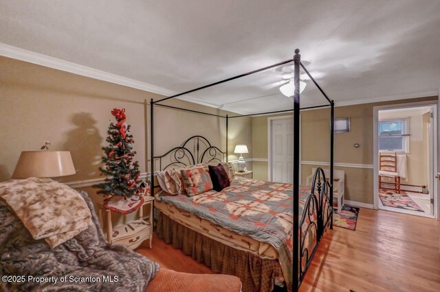 7 Lakeside Dr, Clarks Summit, PA 18411 - bedroom featuring crown molding, wood finished floors, a baseboard radiator, and baseboards