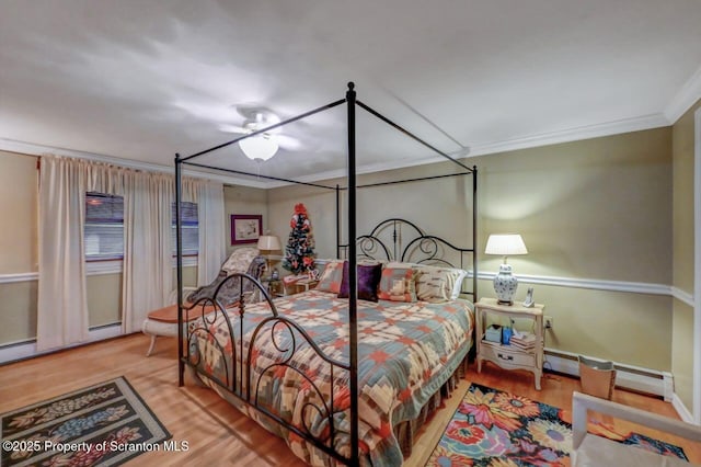 7 Lakeside Dr, Clarks Summit, PA 18411 - bedroom with ornamental molding, baseboard heating, and wood finished floors