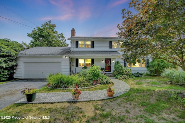 7 Lakeside Dr, Clarks Summit, PA 18411 - traditional-style home with asphalt driveway, a chimney, an attached garage, a lawn, and a porch