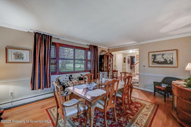 7 Lakeside Dr, Clarks Summit, PA 18411 - dining space with a baseboard radiator, wood finished floors, and crown molding