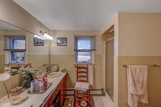 7 Lakeside Dr, Clarks Summit, PA 18411 - bathroom featuring tile walls, a stall shower, a wainscoted wall, vanity, and tile patterned flooring