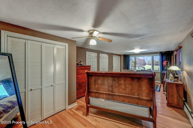 7 Lakeside Dr, Clarks Summit, PA 18411 - bedroom featuring light wood-style floors, a baseboard radiator, a ceiling fan, and baseboards