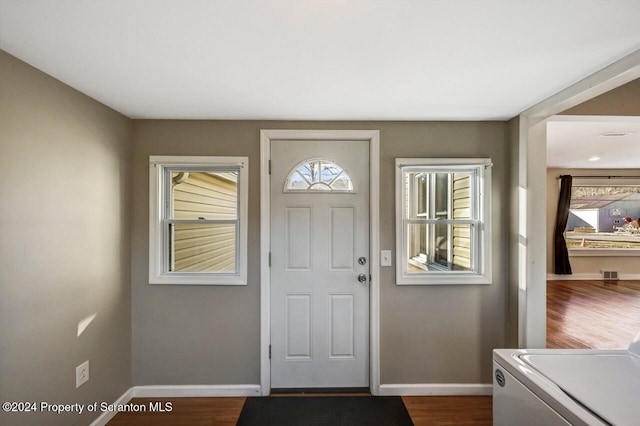 entrance foyer with dark hardwood / wood-style flooring and washer / dryer