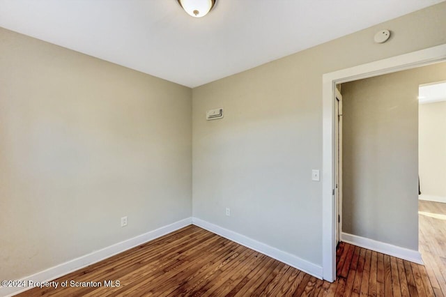 unfurnished room with hardwood / wood-style flooring