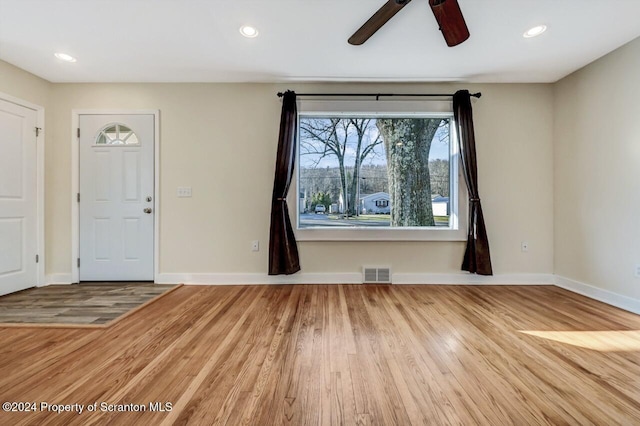 foyer entrance featuring ceiling fan and wood-type flooring