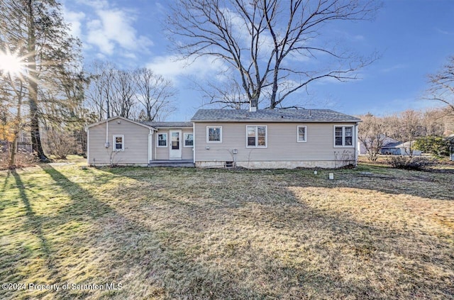 back of house featuring a yard