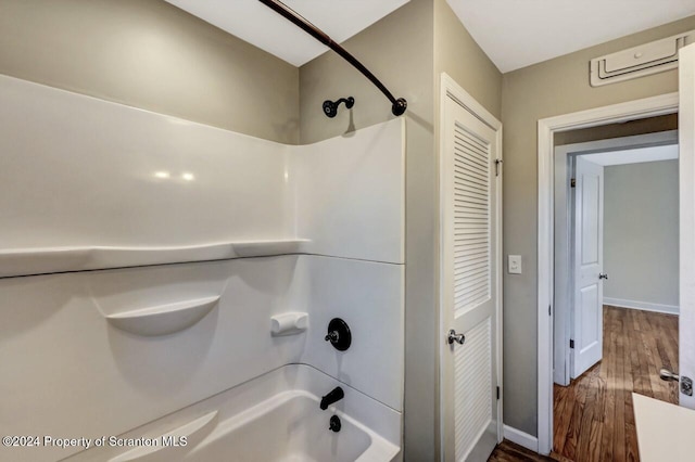 bathroom featuring hardwood / wood-style flooring and shower / bathtub combination