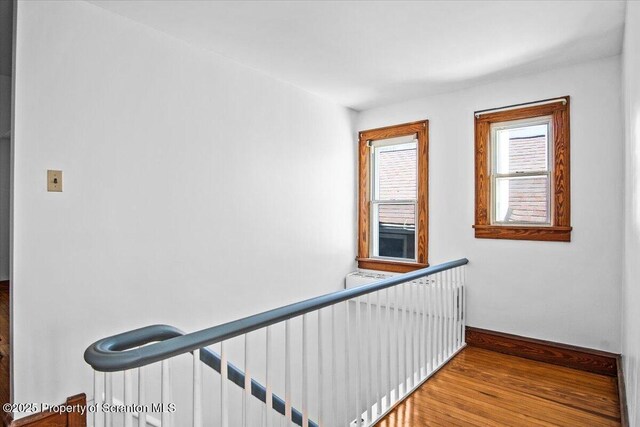 stairs featuring baseboards and wood finished floors