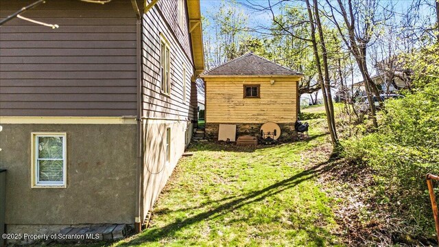 view of side of property featuring stucco siding and a yard
