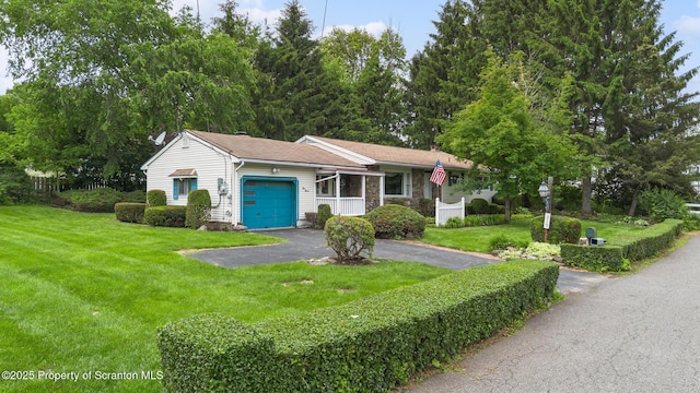 315 Delin Dr, South Abington Twp, PA 18411 - view of front of property featuring an attached garage, driveway, a front yard, and stone siding