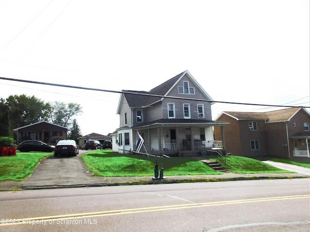 view of front facade with covered porch and a front yard