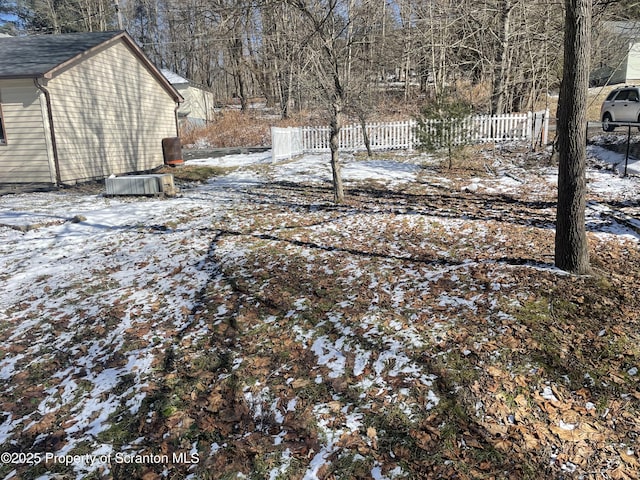 yard covered in snow with fence