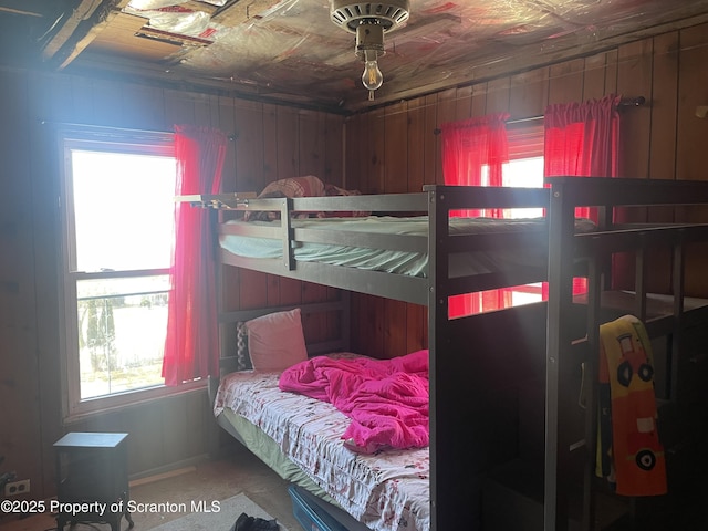 bedroom with wooden walls and an ornate ceiling